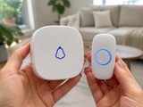 Hands holding the HomeChime call button and receiver