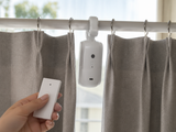 GlideGlow curtain robot with its remote control